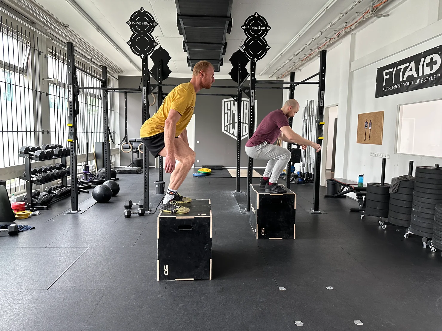 2 athletes doing box jumps