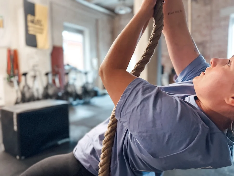 A woman is holding onto a rope