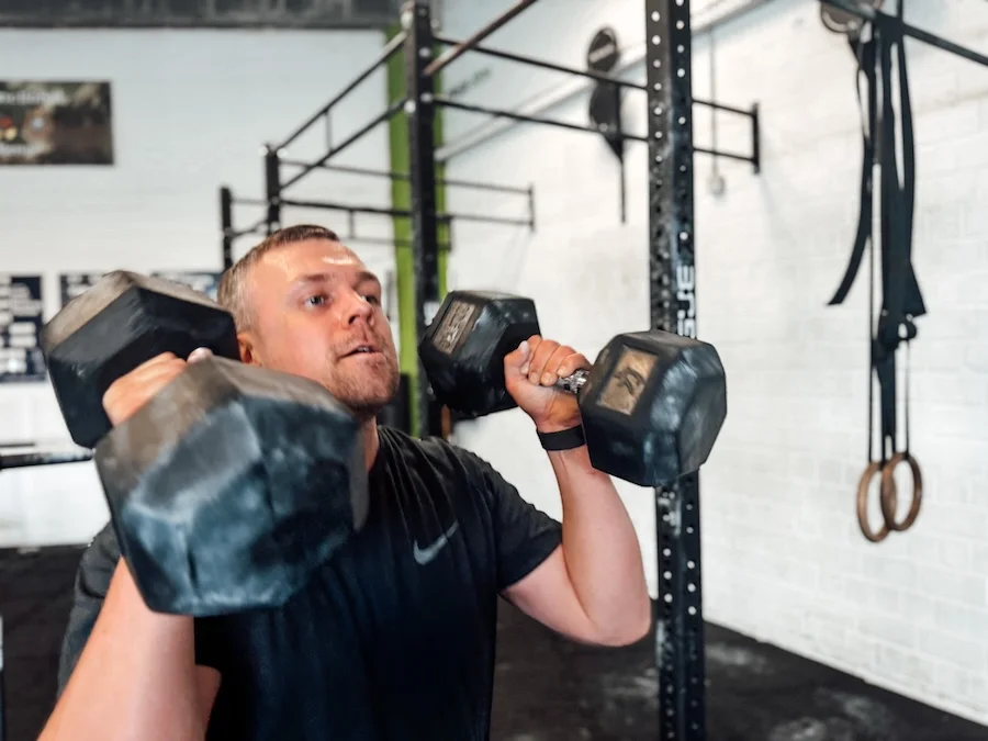athlete training with dumbbells