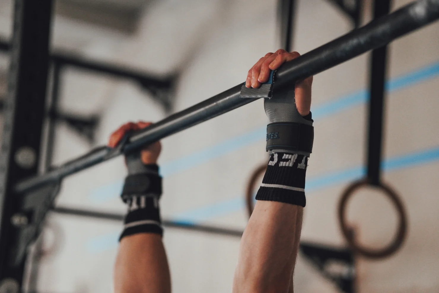 Athlete hanging from a pull-up bar