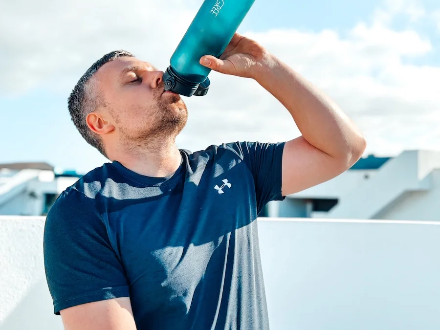 Athlete drinking water in summer
