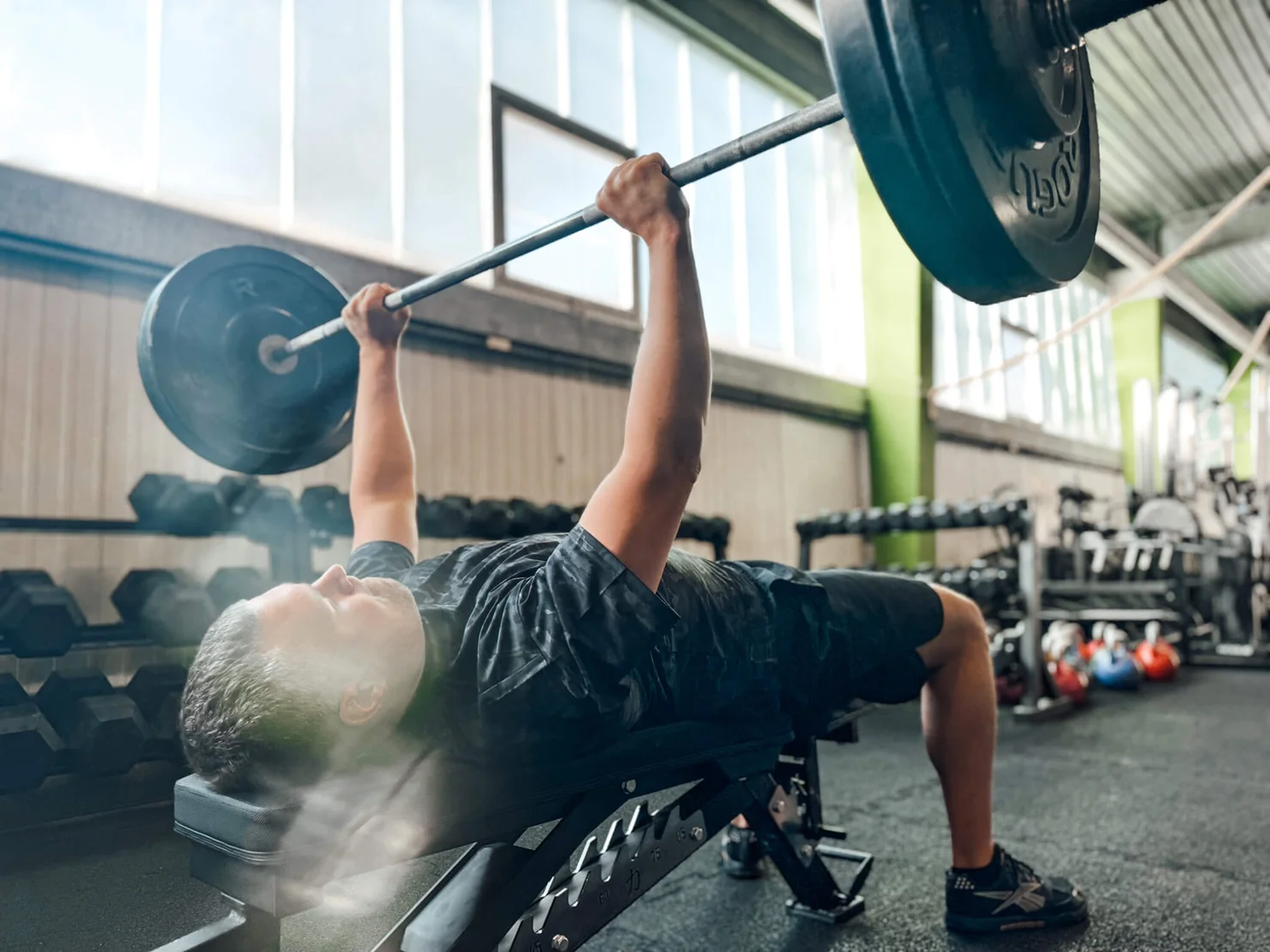athlete doing a bench press with a barbell