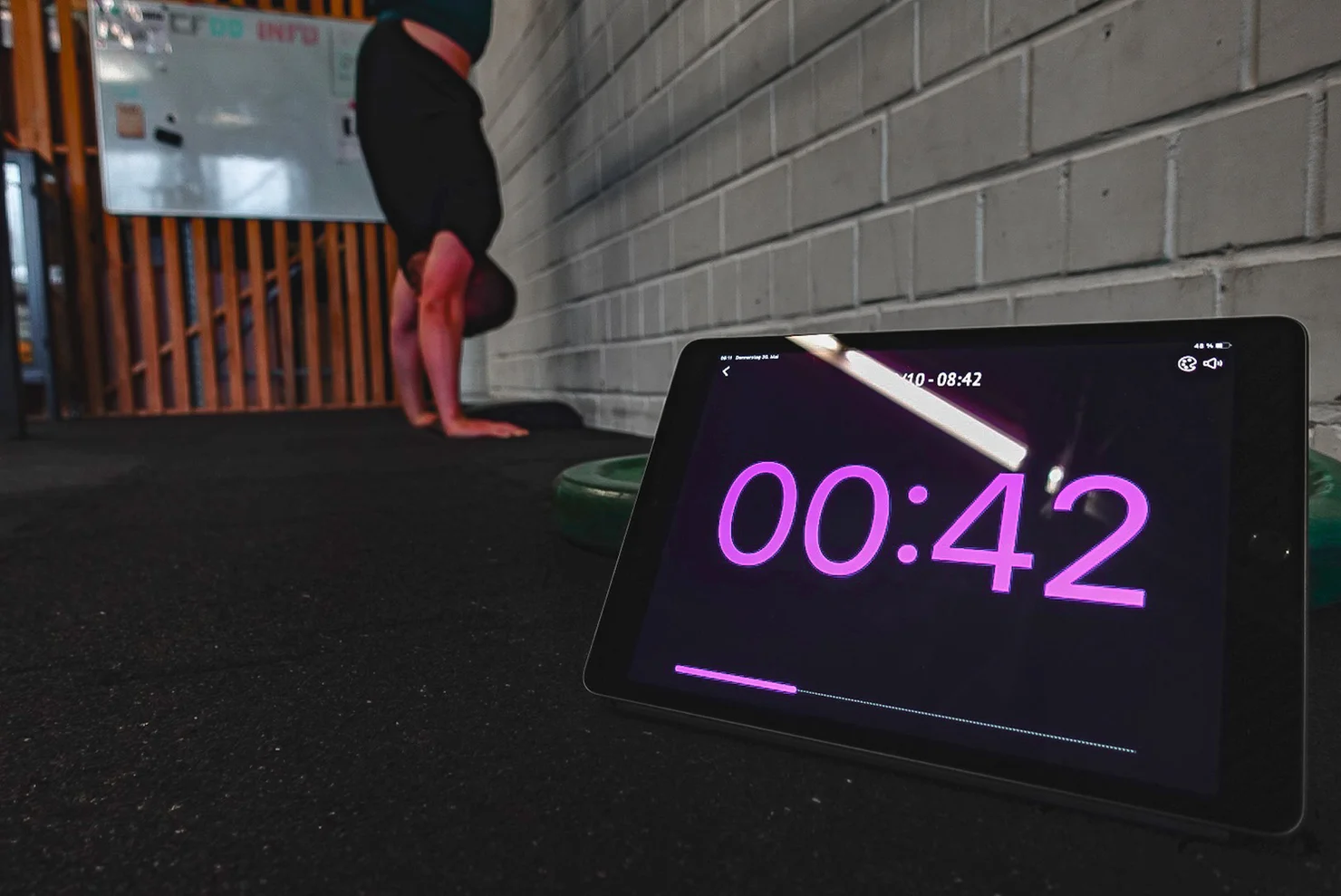 Athlete doing a handstand with a timer