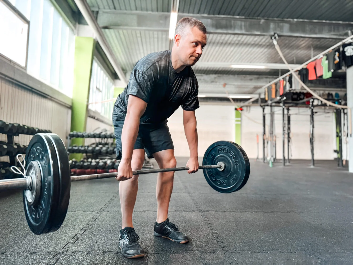 athlete doing deadlifts with a barbell