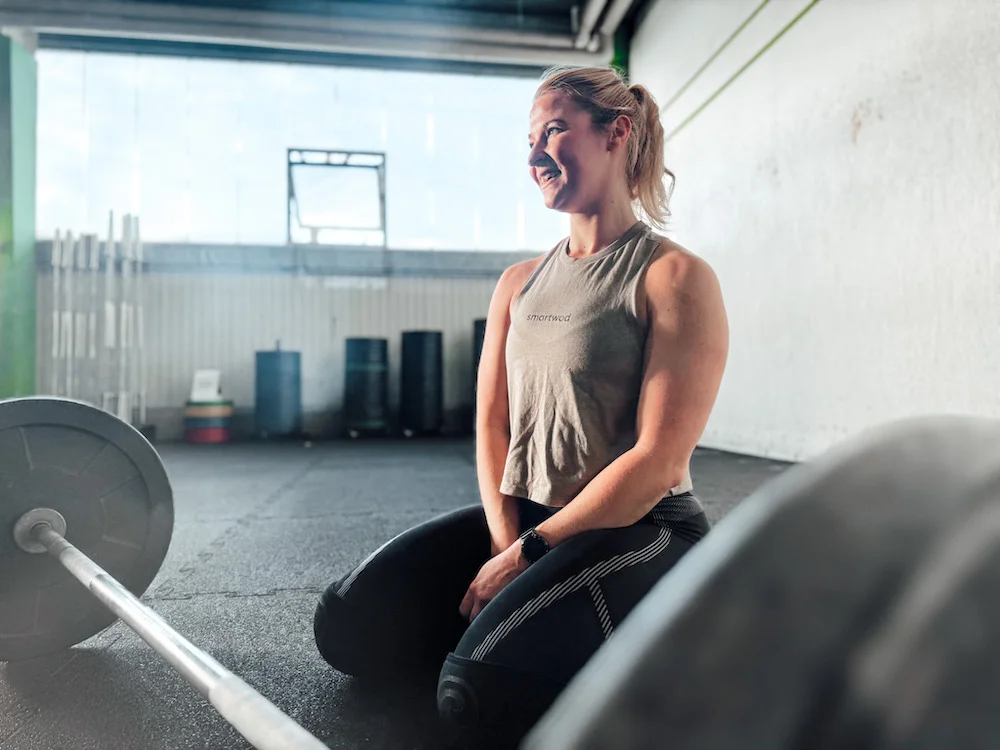 athlete in front of a barbell