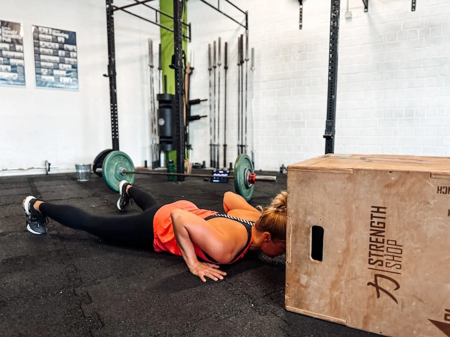 Athlete performing burpee box jumps