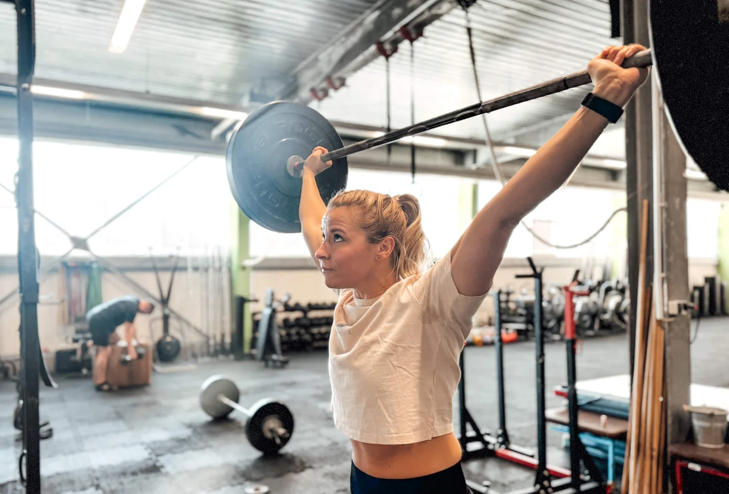 athlete training with a barbell overhead