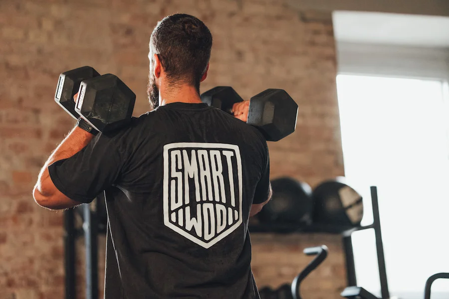 athlete training with dumbbells