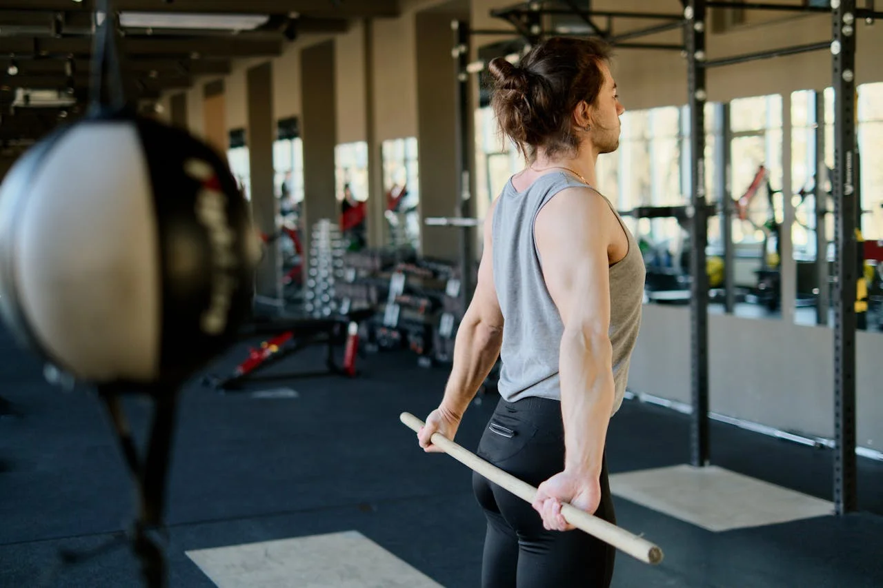 Athlete warming up with a PVC bar