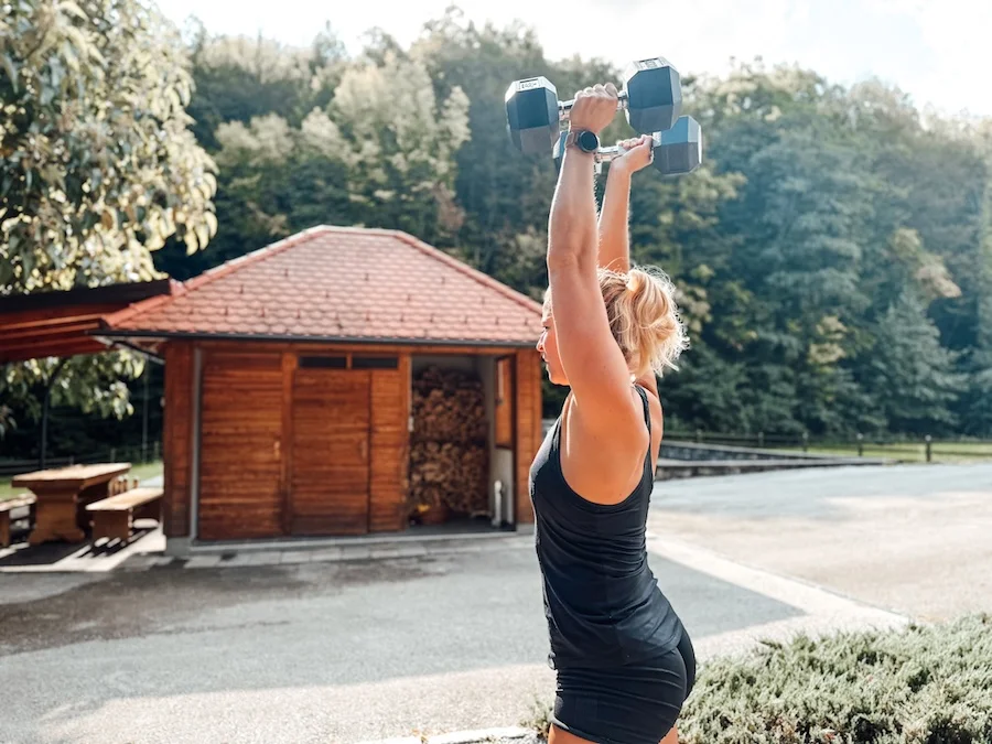 Athlete performing a dumbbell push press