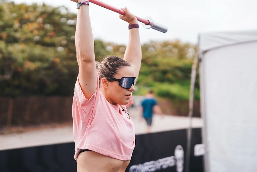 An athlete warming up with a barbell