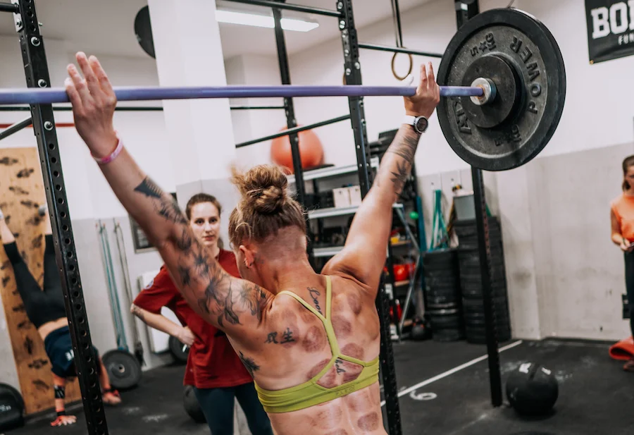 Female athlete working out with a barbell
