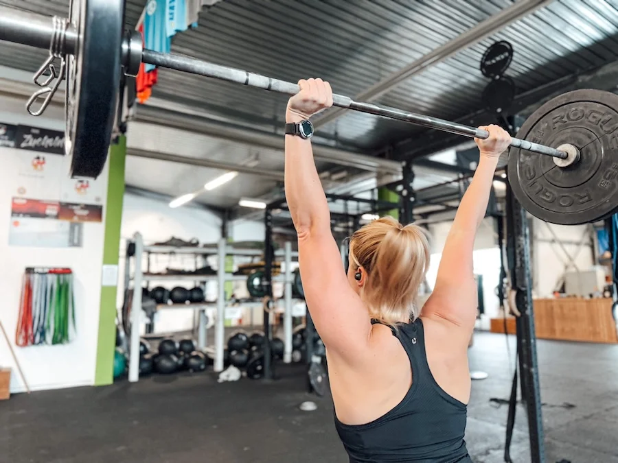 Athlete lifting a barbell overhead