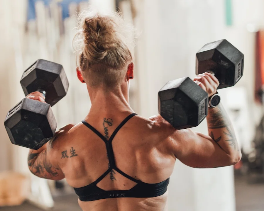 Athlete training with dumbbells