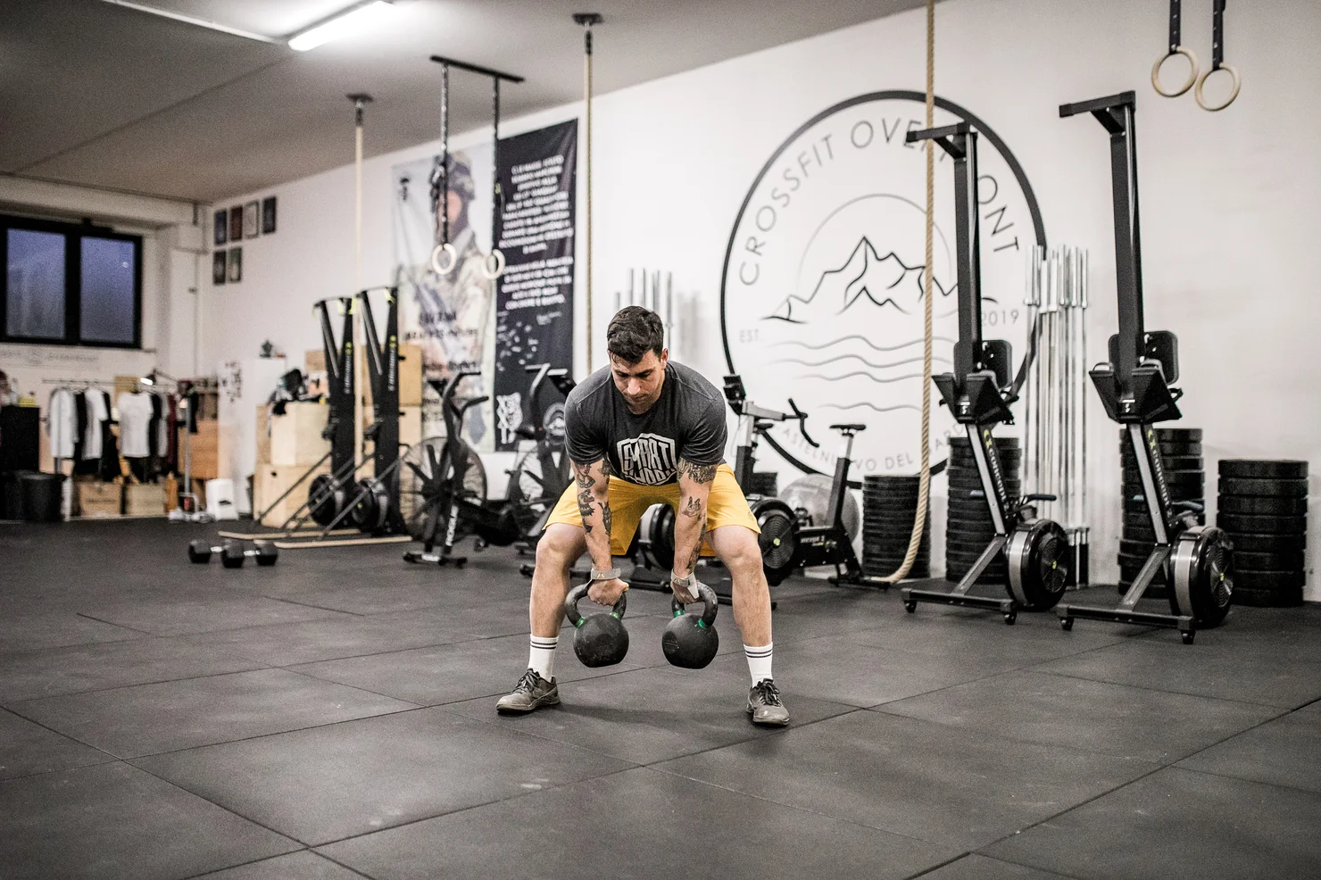 CrossFit athlete training with two kettlebells