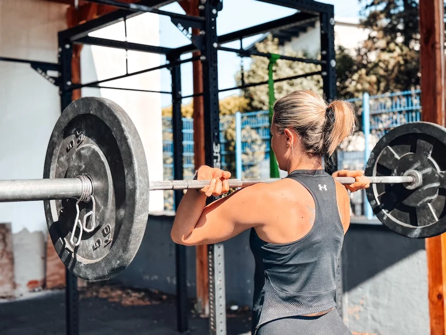 Female athlete with a barbell on her shoulders