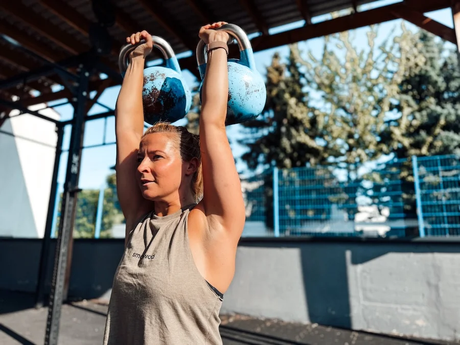 Female athlete with kettlebells
