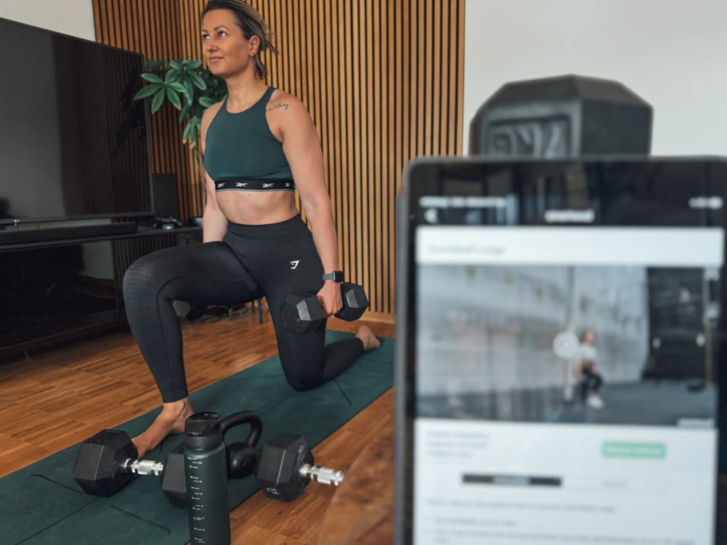 Female doing lunges with dumbbells