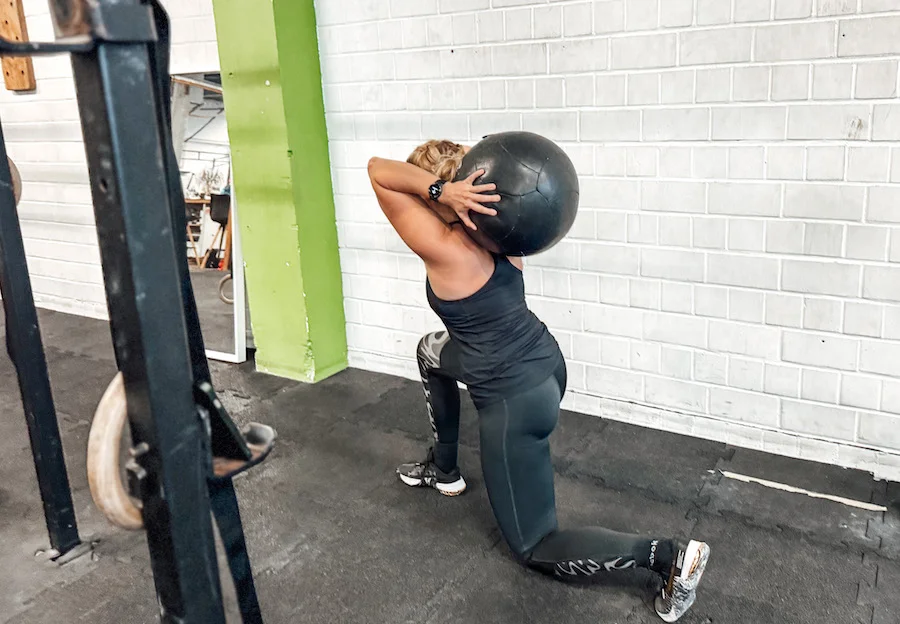woman doing a workout with a wall ball