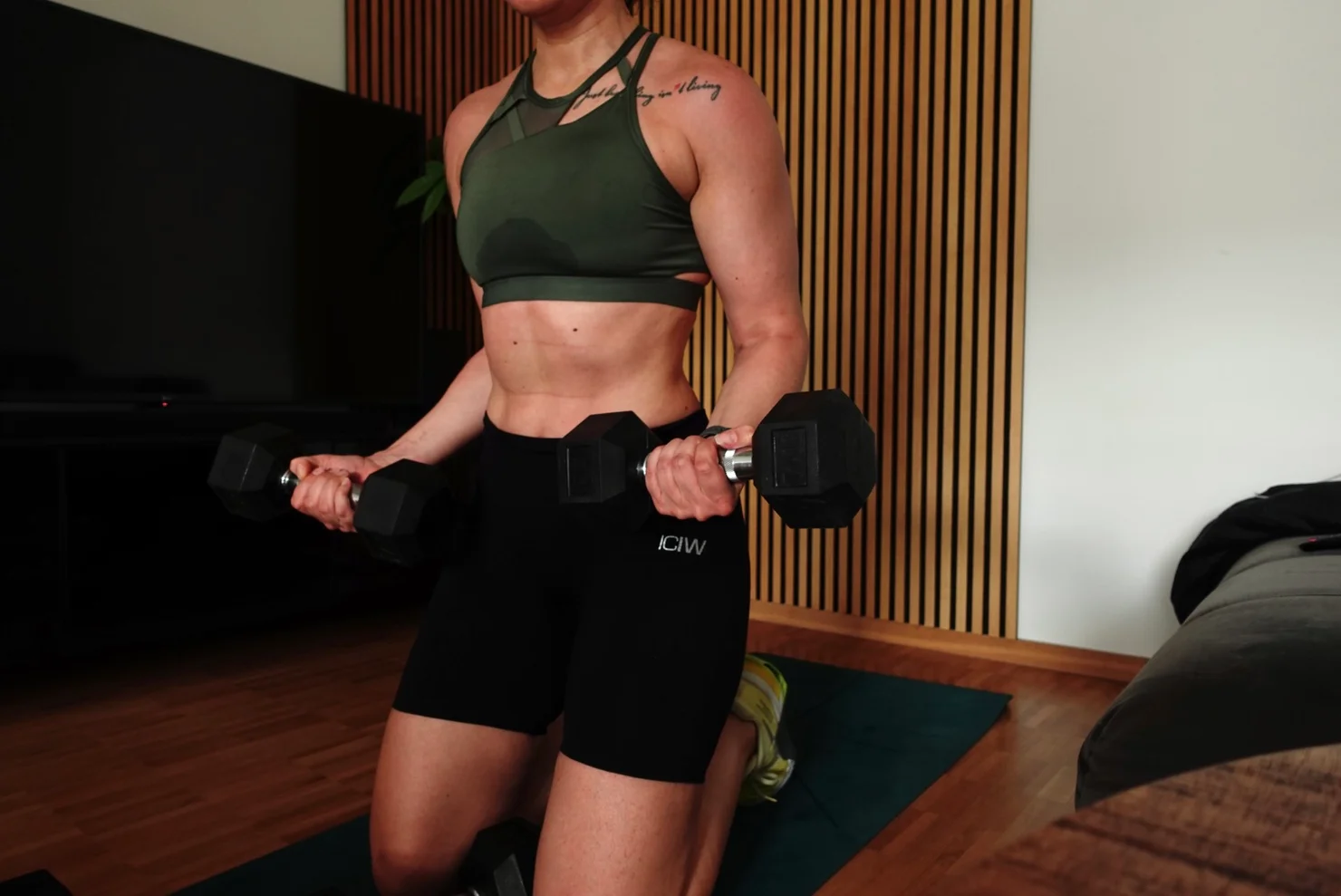 Female athlete training with dumbbells