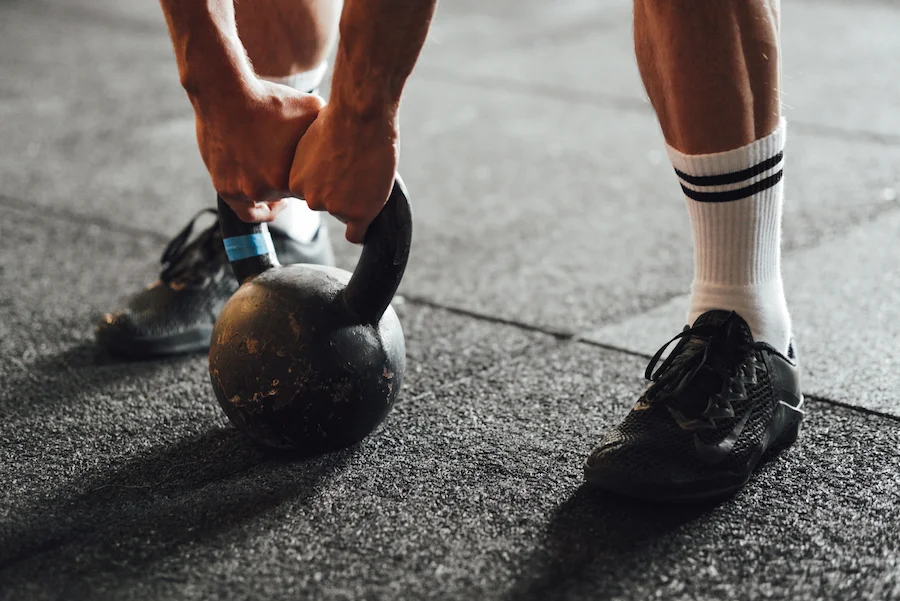 man training with a kettlebell