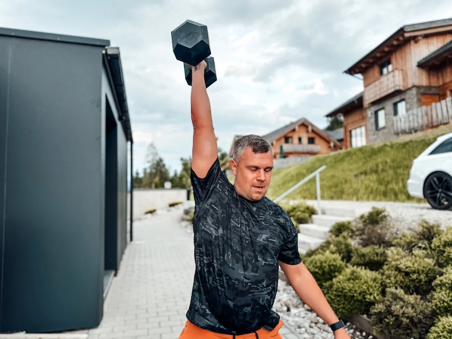 Man doing a single arm dumbbell snatch
