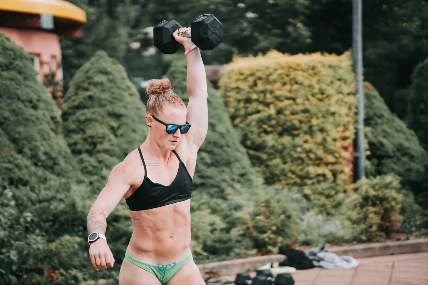 Female athlete training with one dumbbell