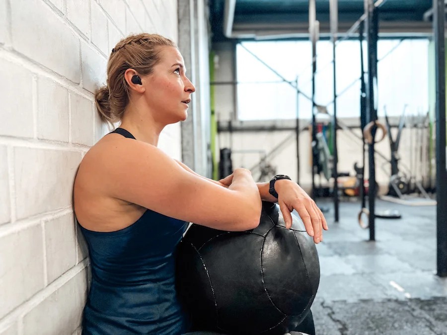 Woman doing a wall sit with a wall ball