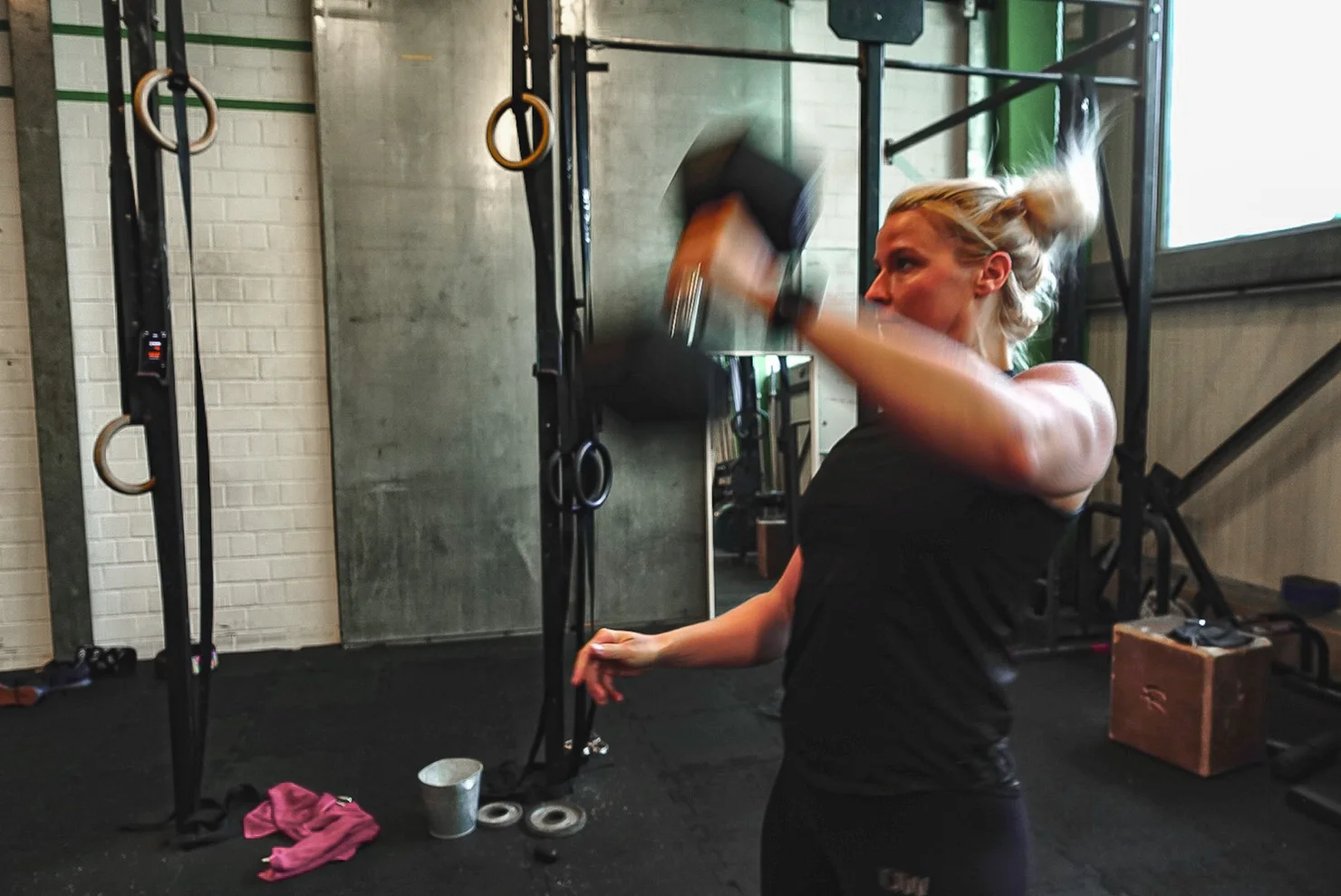 Woman training with one dumbbell